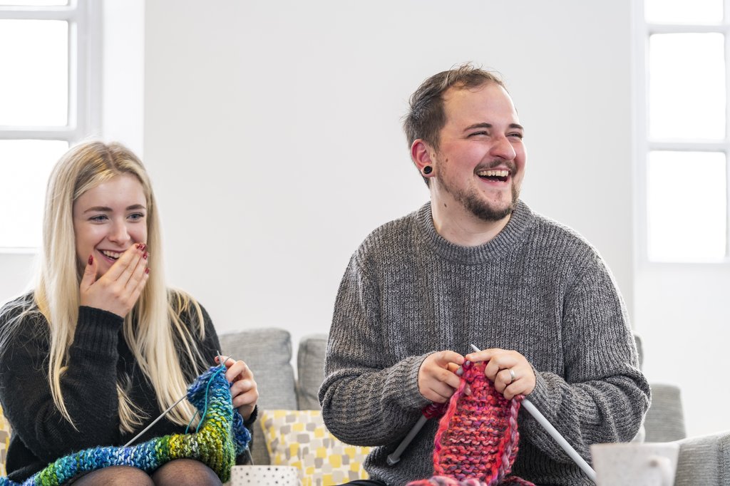 Two people knitting