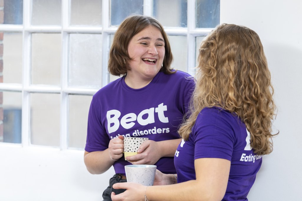 Two people having a coffee in Beat t shirts