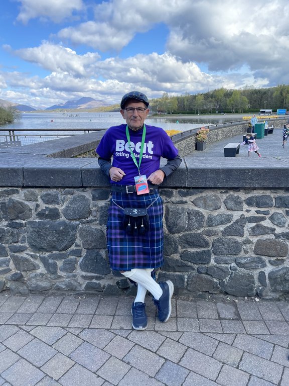 Man raising hat as he walks the Kiltwalk