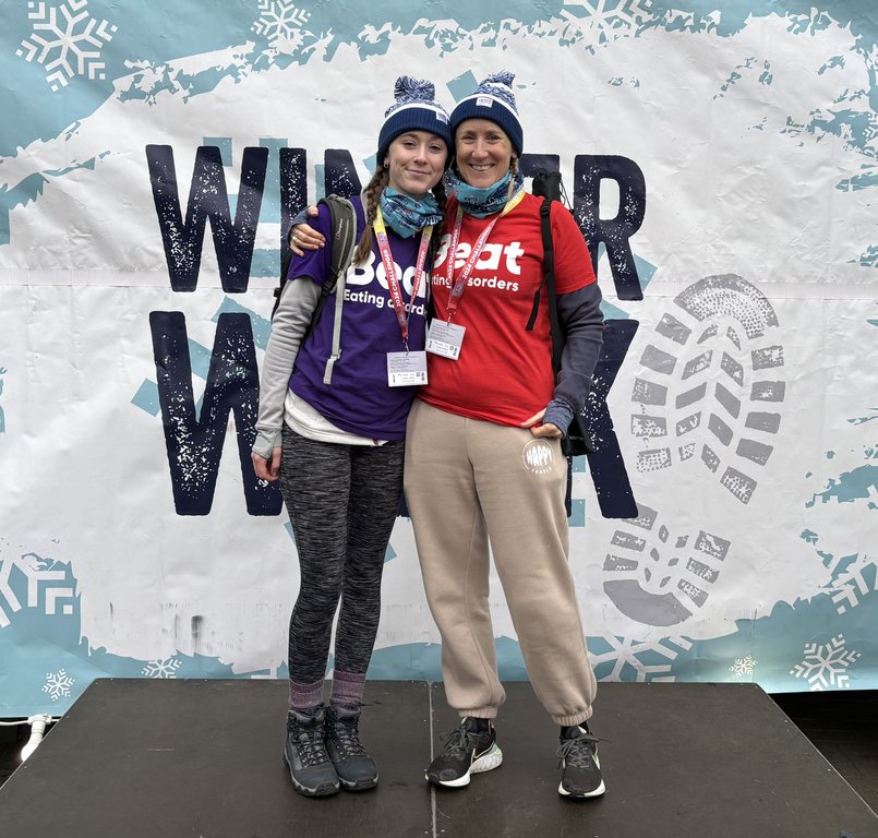 Two women at the finish point wearing Beat t-shirts