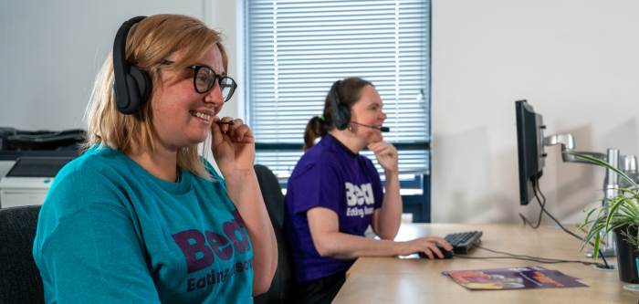 People sat in an office answering our helpline