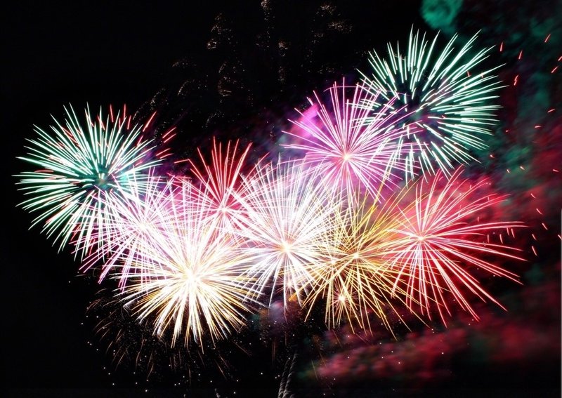 A photograph of some multi-coloured fireworks set across a background of a night sky.